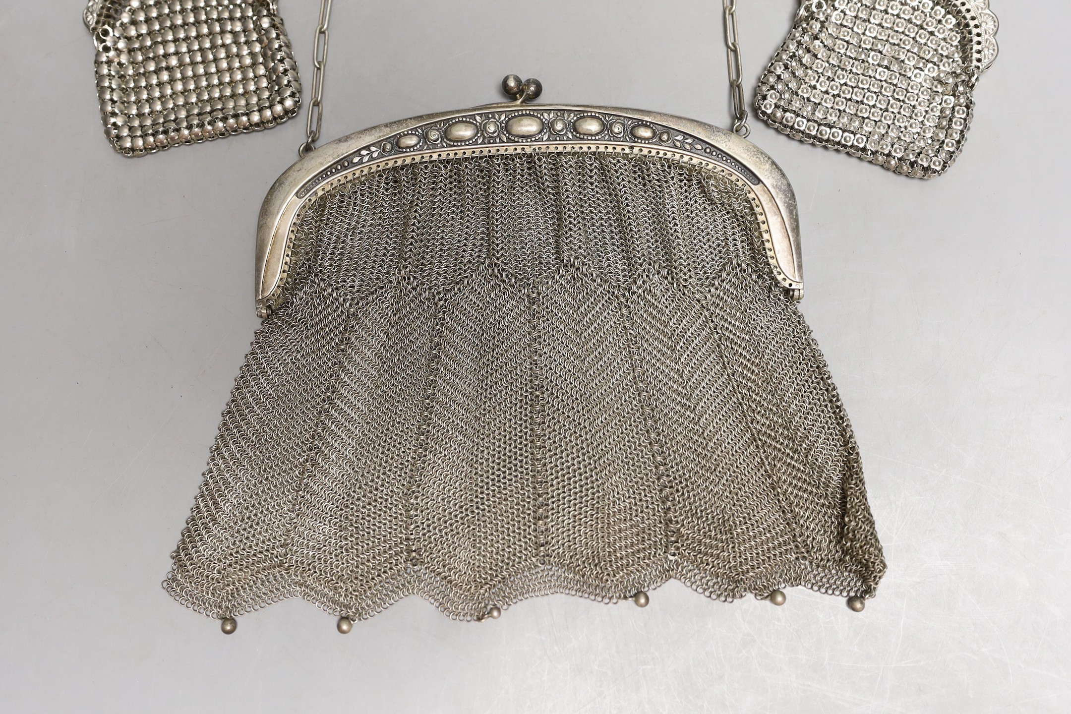 A chain mail metal evening bag and two similar purses.